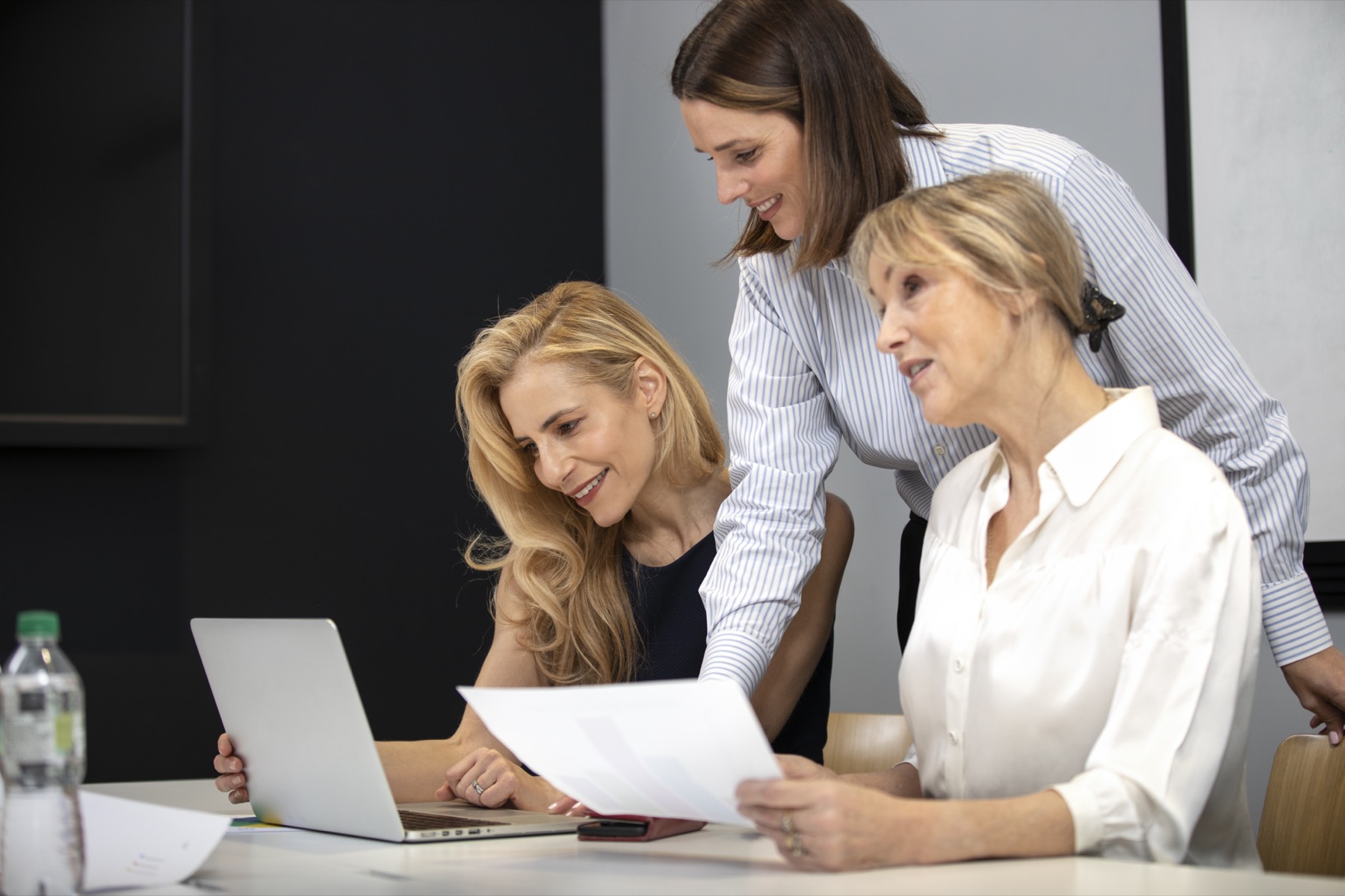 Woman smiling while working on her laptop